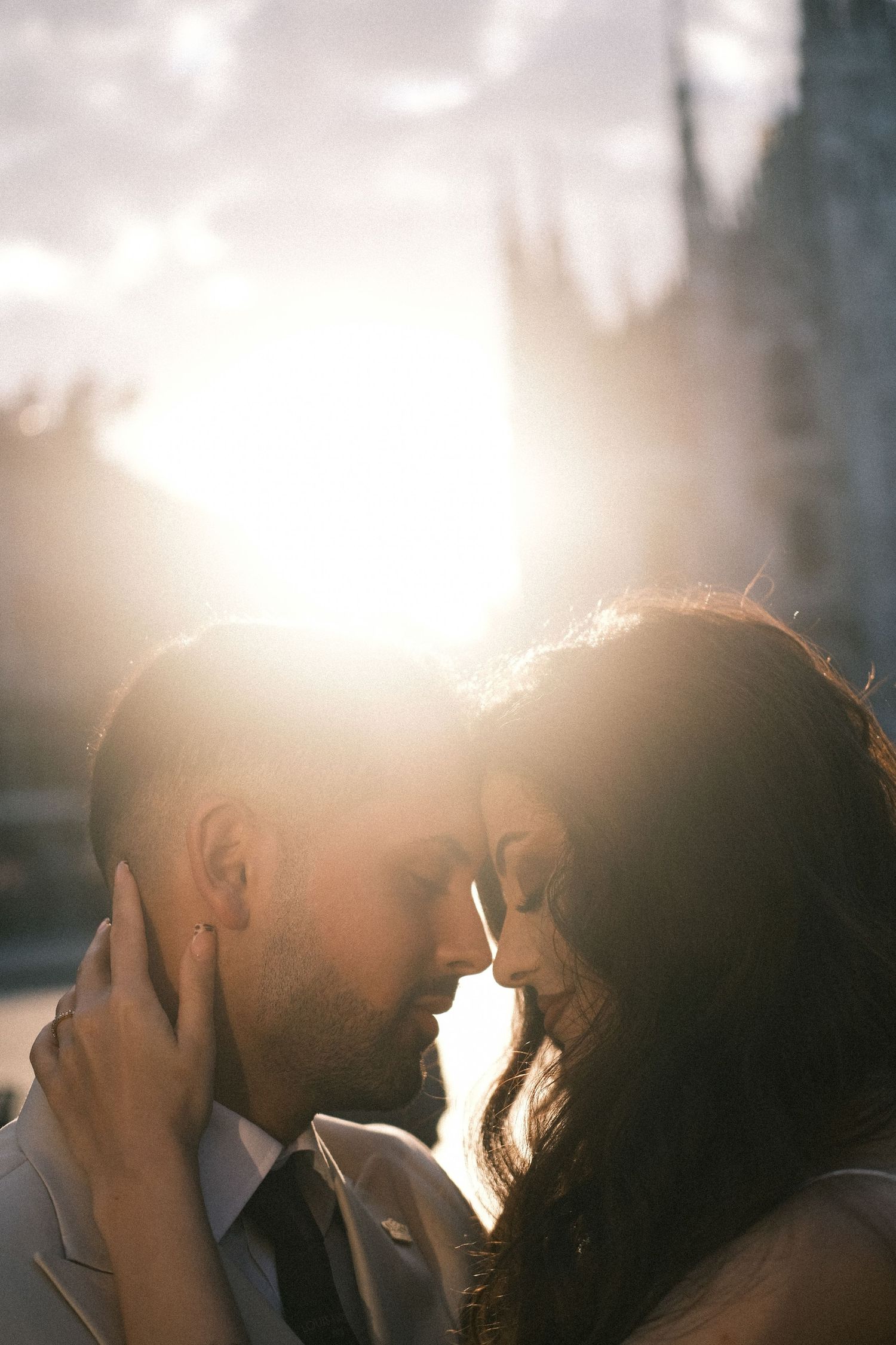 Intimate forehead kiss Milan Duomo golden hour