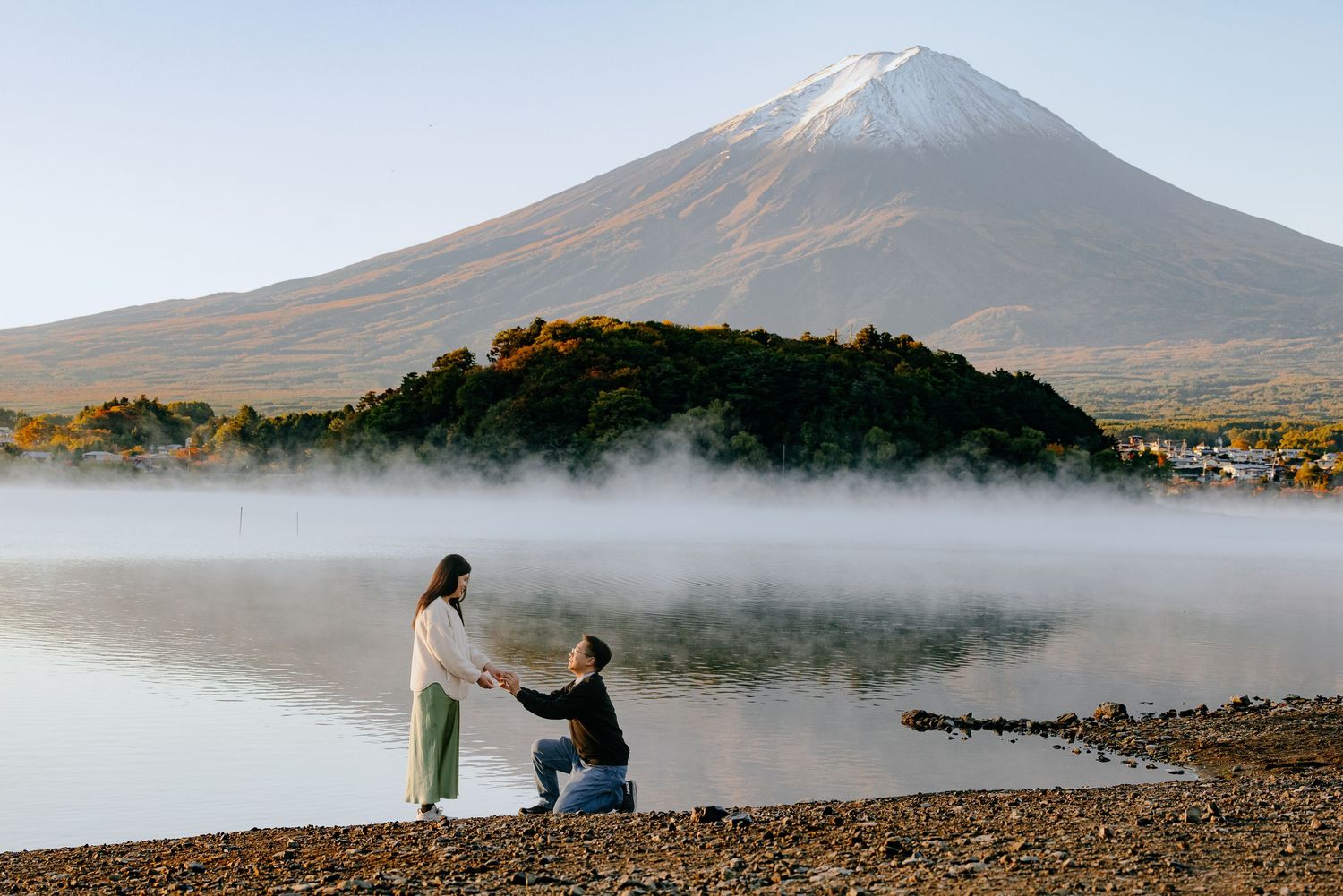 Panoramic sequence of misty morning at a volcanic mountain lake with silhouetted figures on the shore.