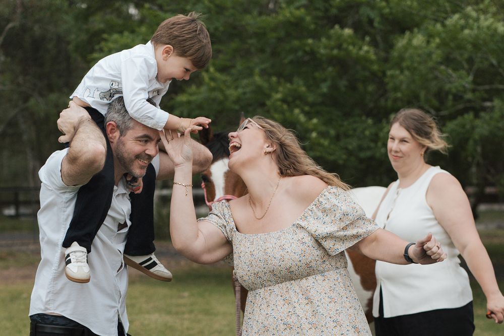 joyful moments between a family in a garden setting during a family photoshoot