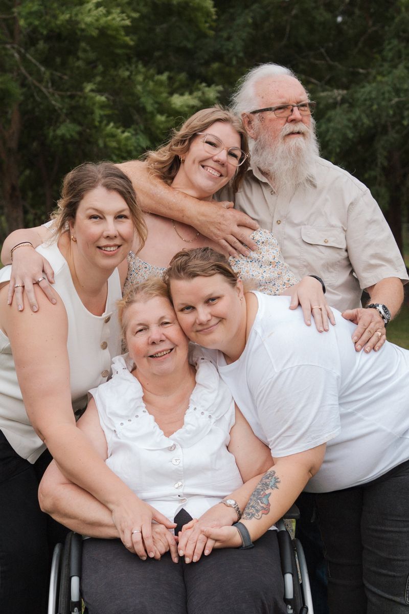 A joyful family photo series showing loved ones embracing and smiling together outdoors in casual attire in Sydney family photoshoot The gab