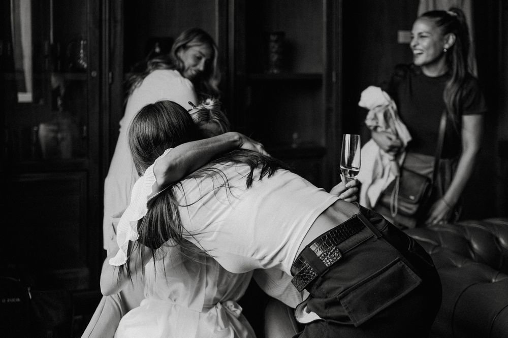A couple in wedding attire shares an intimate dance together in a dimly lit setting.