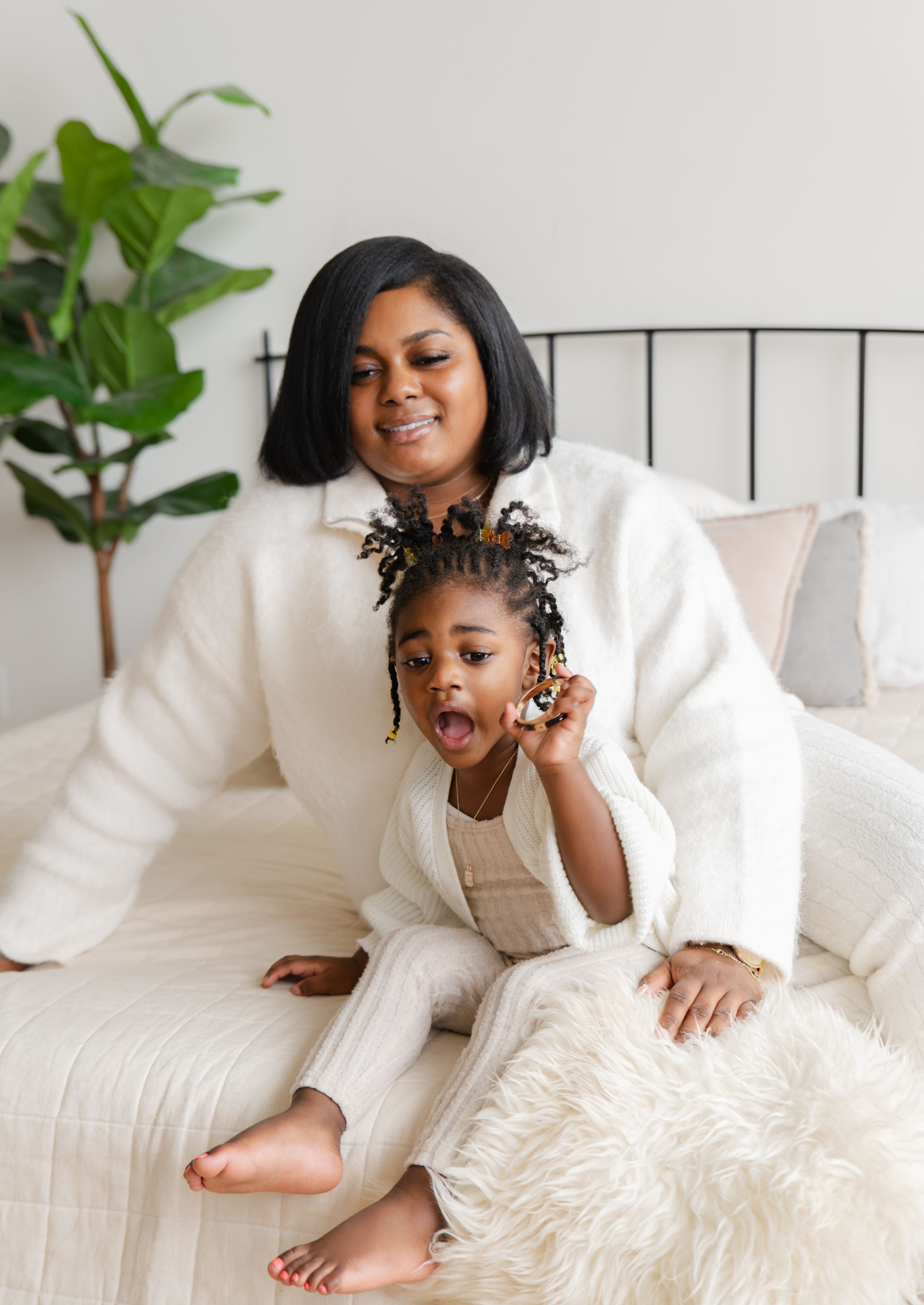 A sequence of four photos showing joyful moments on a white couch with decorative pillows and plants in the background.
