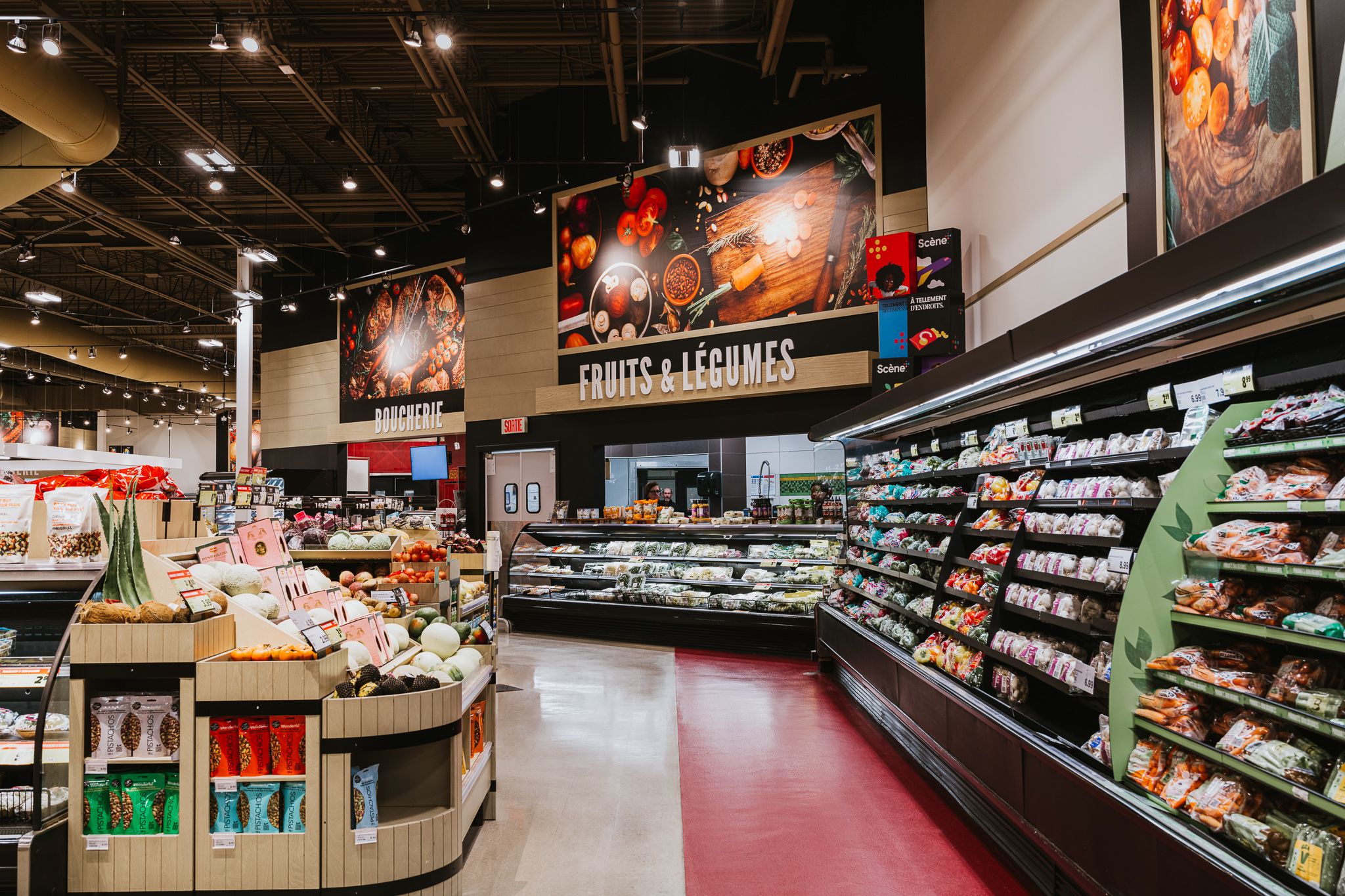 Panoramic view of grocery store aisles with shelving and product displays.