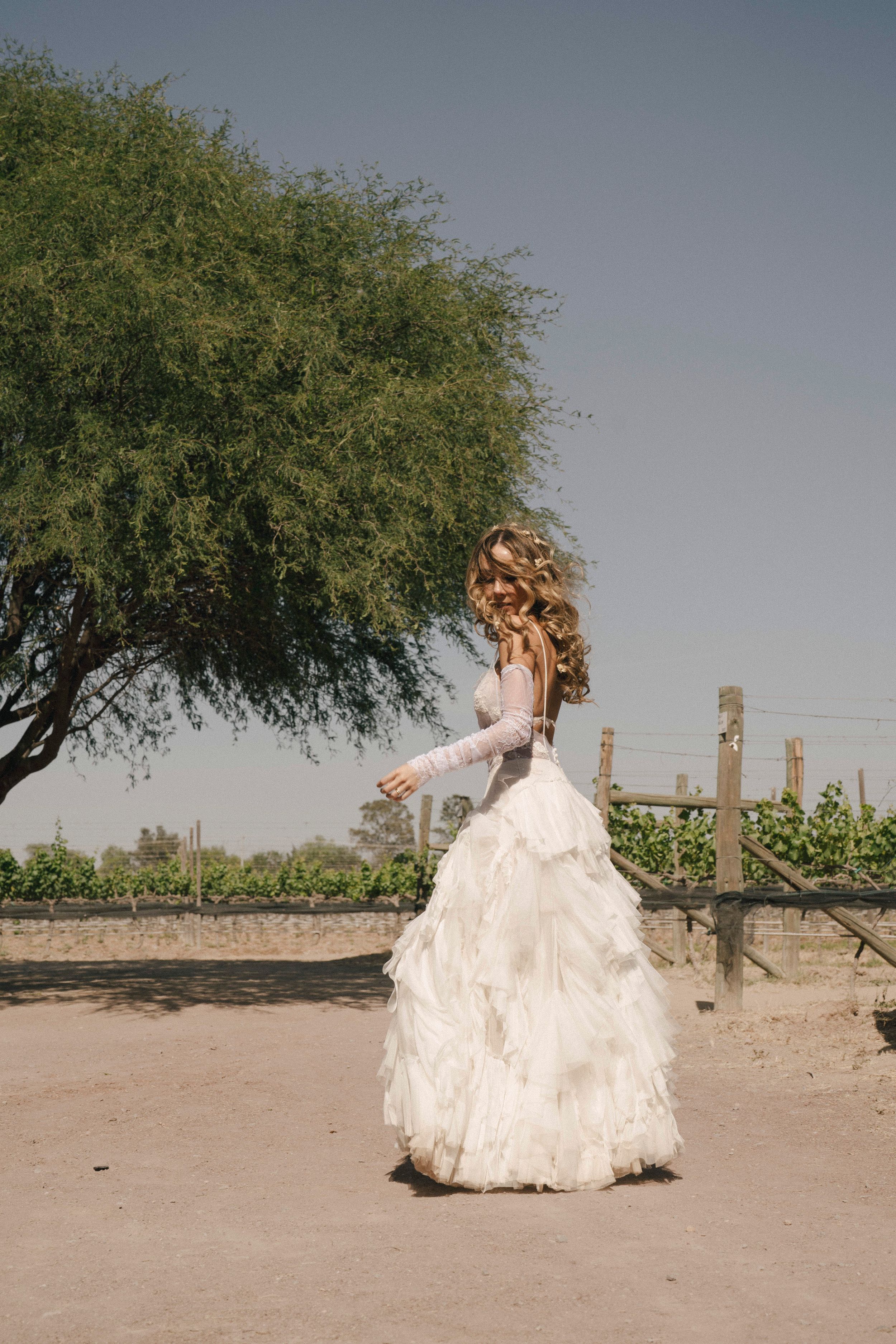 Close-up detail of delicate white lace sleeves and flowing tulle fabric from a romantic wedding dress.