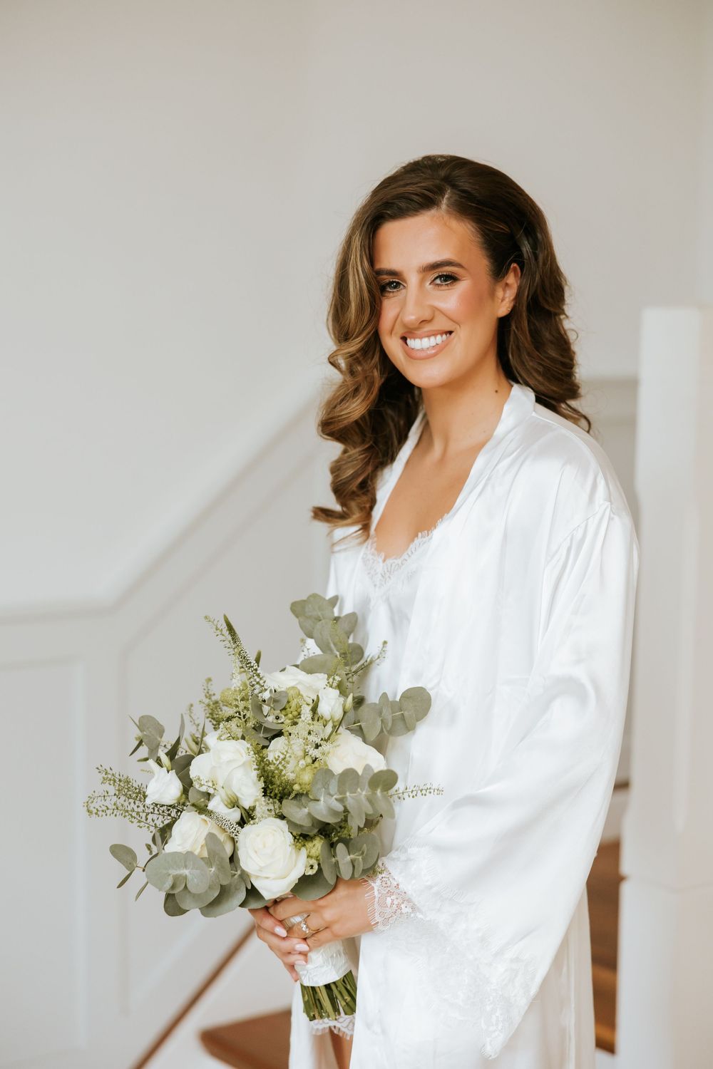 Elegant bridal morning preparations featuring white robes and a beautiful eucalyptus bouquet. Castle Leslie