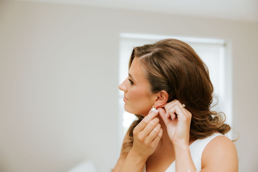 A woman applies makeup in a series of close-up beauty shots showing different cosmetic application techniques. Castle Leslie
