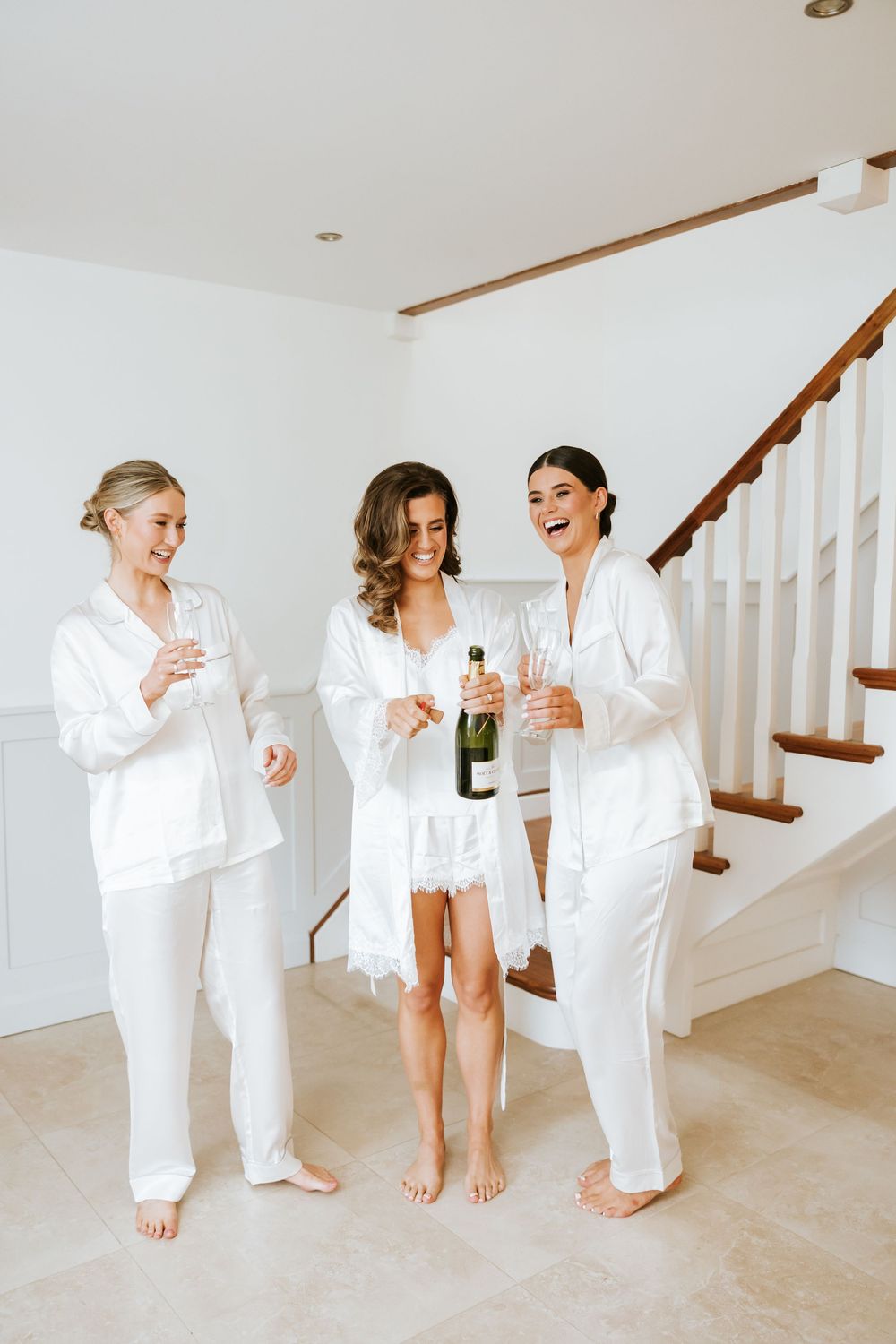 A group wearing matching white robes sits together on a light-colored floor. Castle Leslie