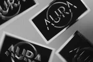 Close-up view of black and white luxury brand logos and text printed on glossy surfaces.