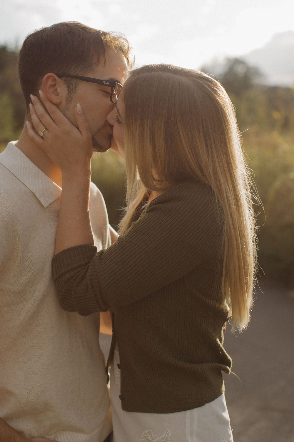 A tender moment shared between two people during golden hour outdoors.