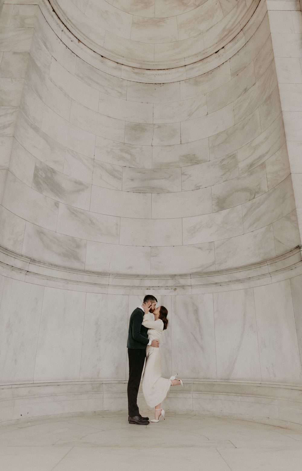 A minimalist photo series showing a couple dancing in an elegant white domed architectural space.