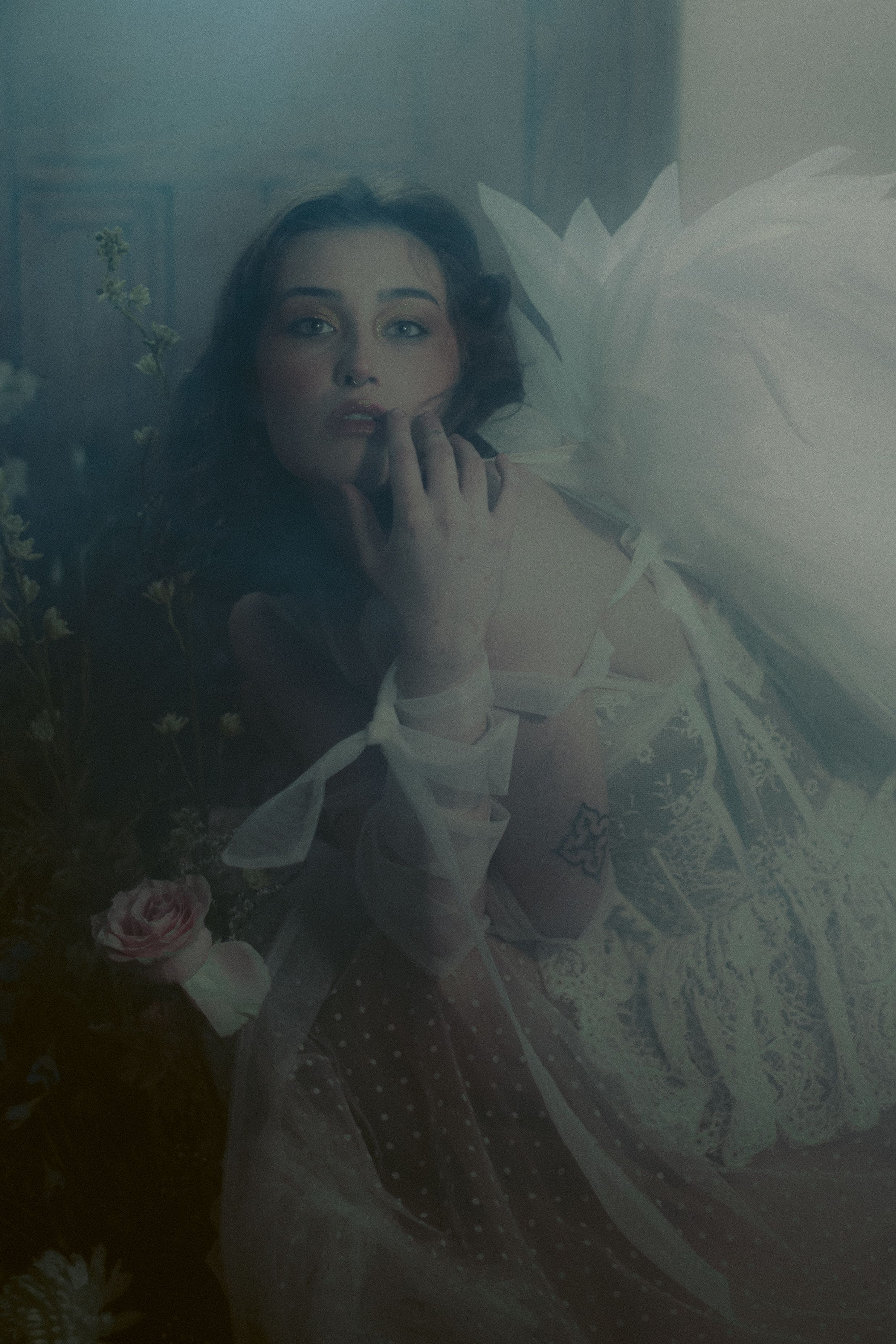 Ethereal double exposure portrait with flowing white fabric and dreamy lighting creates mysterious artistic effect.