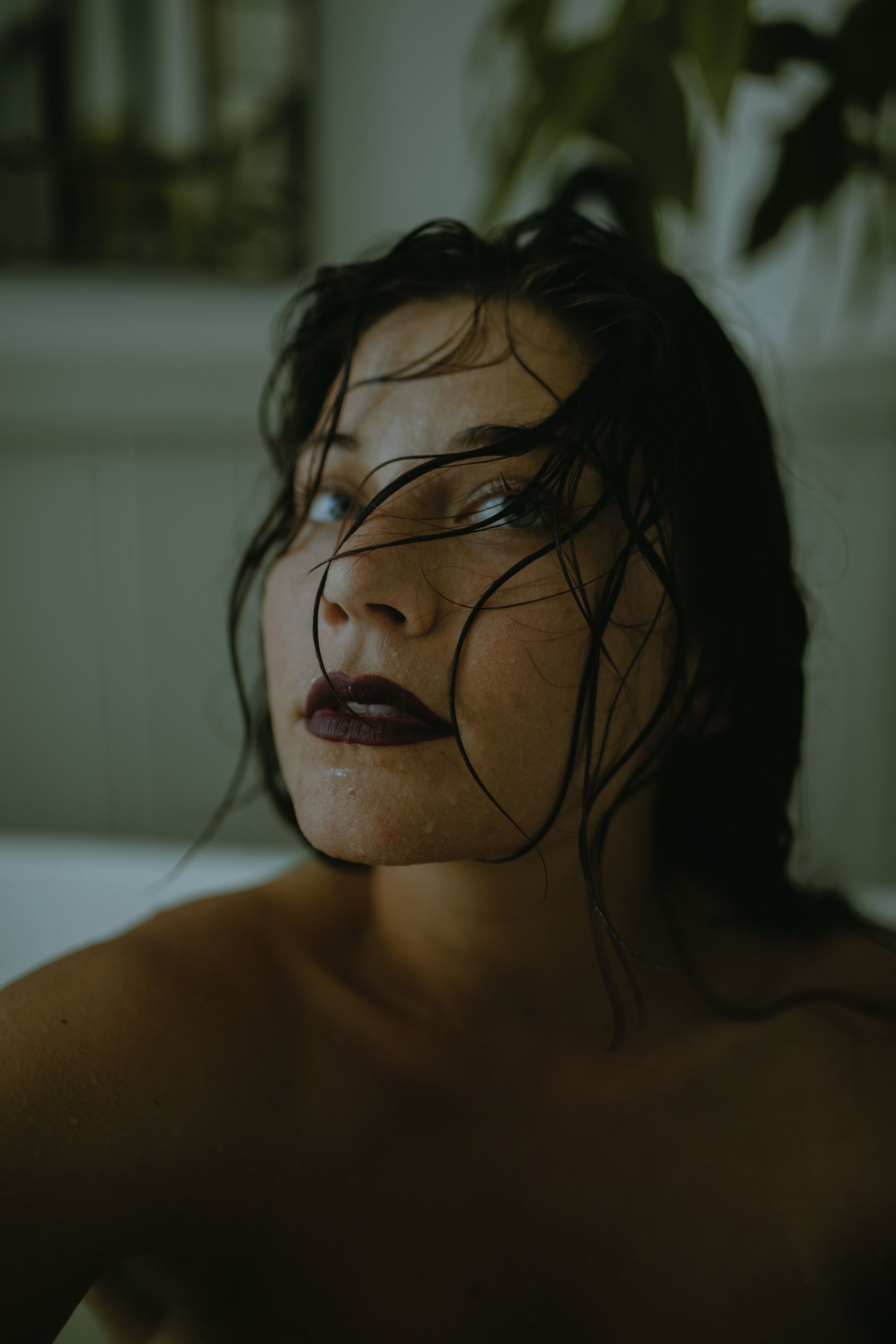 Artistic portrait series showing a person with wet hair in dramatic lighting against a dark background.