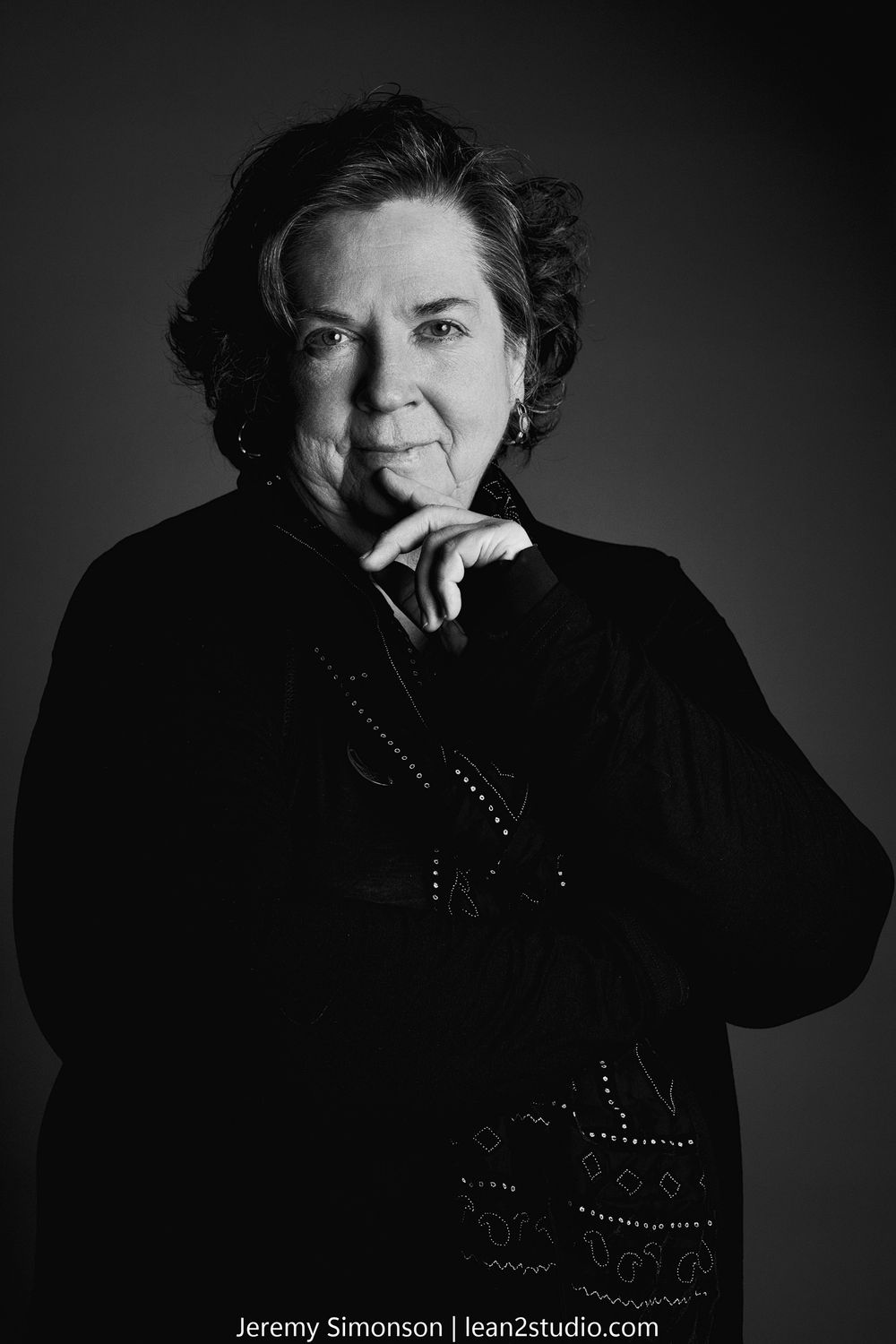 Dramatic black and white portrait series showing emotional expressions against dark background.