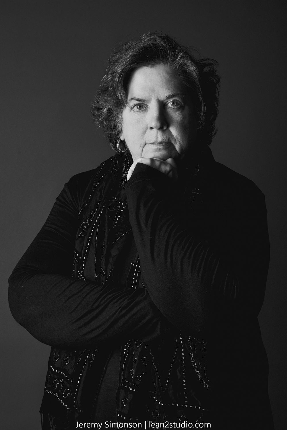 Black and white portrait series showing moody dramatic lighting and cigarette smoke in dark studio setting.