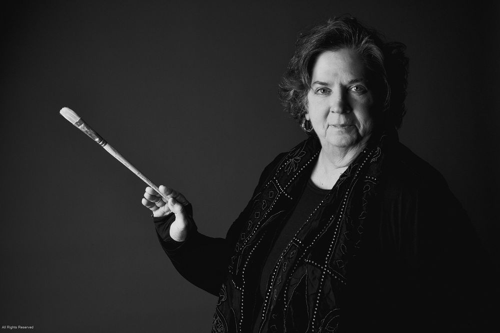A dramatic black and white portrait series with dark background and moody lighting.