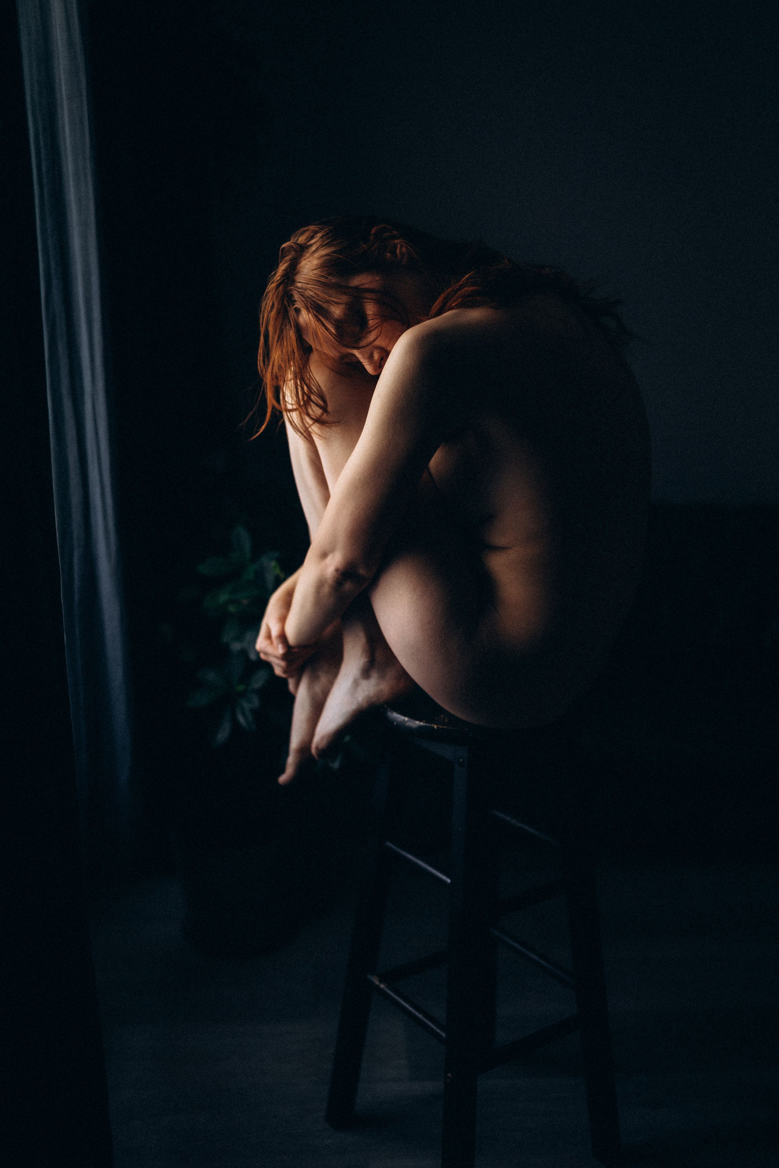 A dark and moody artistic portrait series showing a figure in silhouette against a black background.