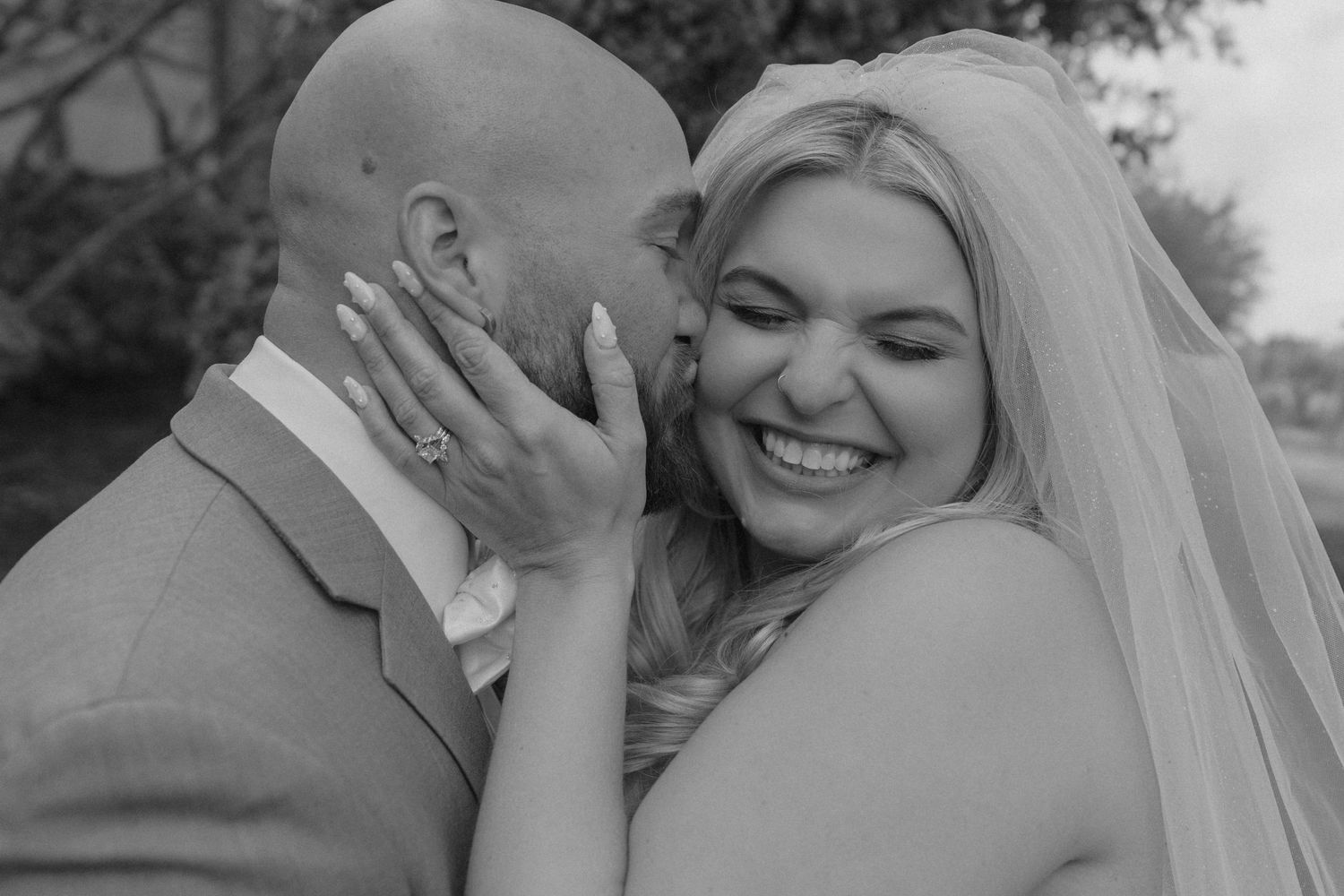 Black and white wedding portraits capturing intimate moments between newlyweds.