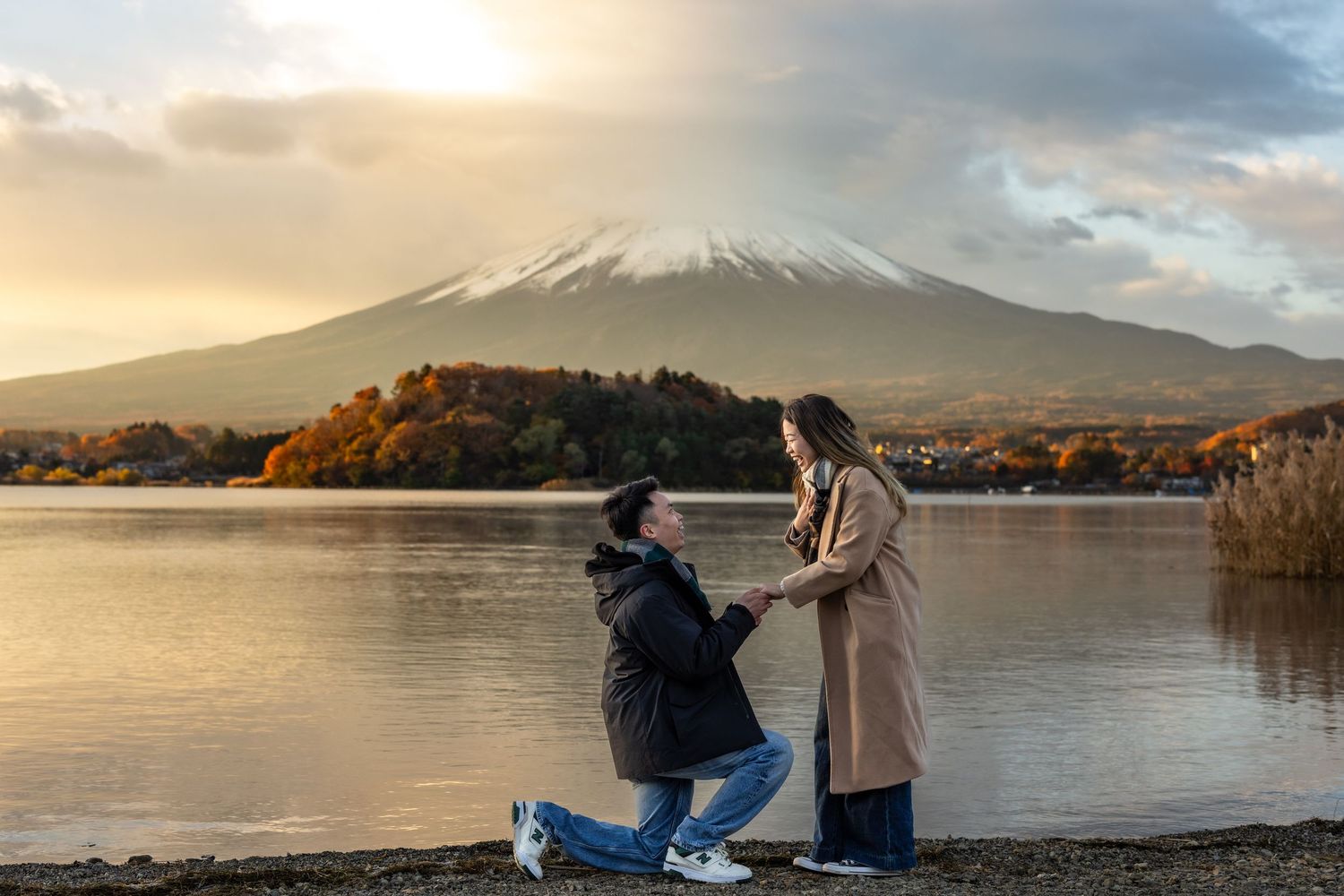 A couple gets engaged during sunset by Lake Yamanaka with Mount Fuji in the background.