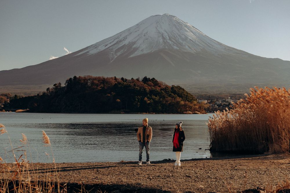 Scenic mountain landscape view with Lake Yamanaka and Mount Fuji in Japan during golden sunset hour.