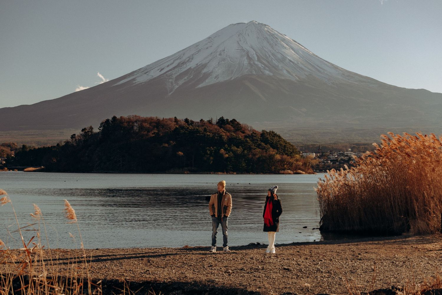 Scenic mountain landscape view with Lake Yamanaka and Mount Fuji in Japan during golden sunset hour.