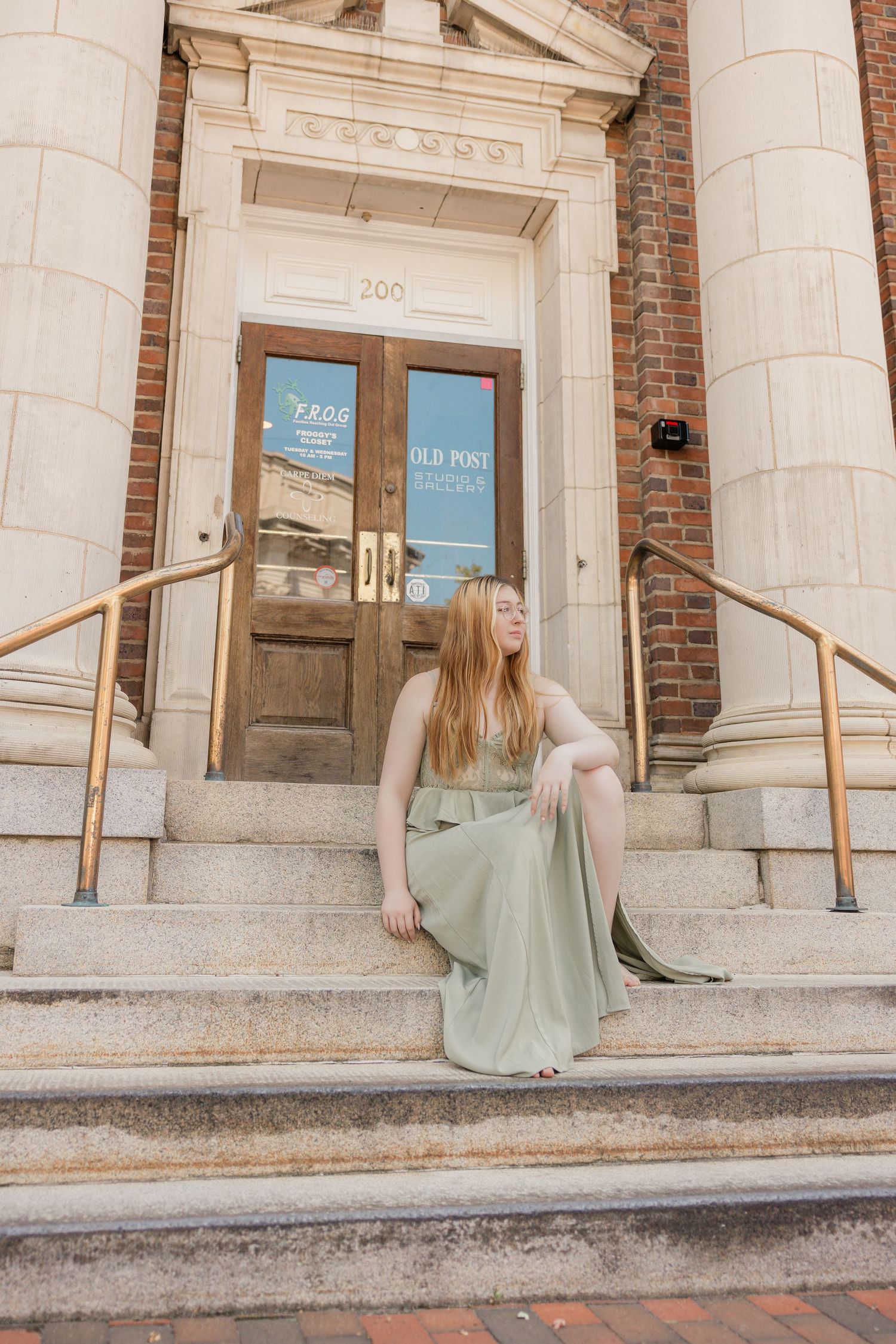 Series of casual poses on stone steps outside classic building with columns.