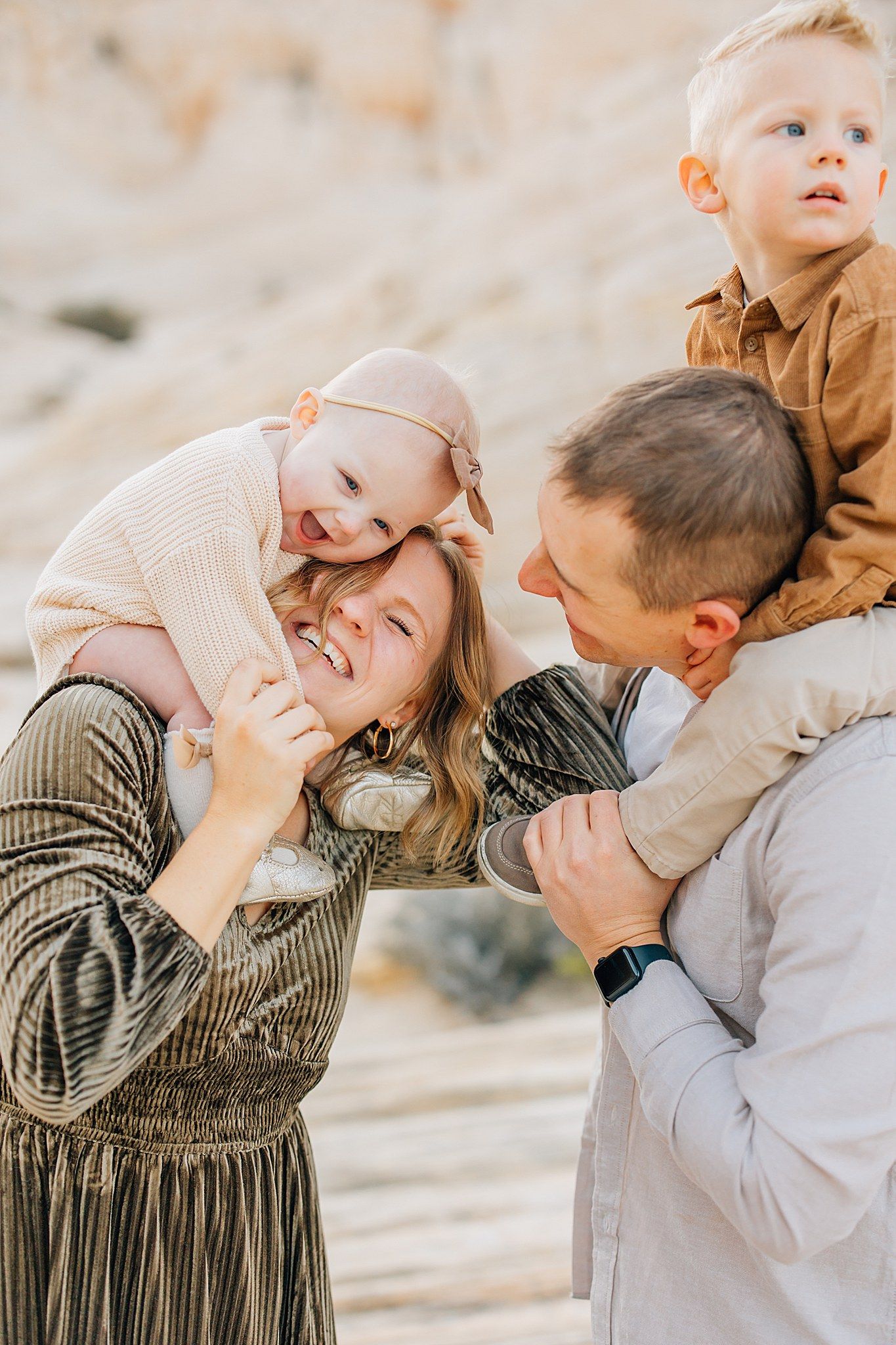 A series of candid family photos showing tender moments of affection and laughter against a neutral outdoor backdrop.
