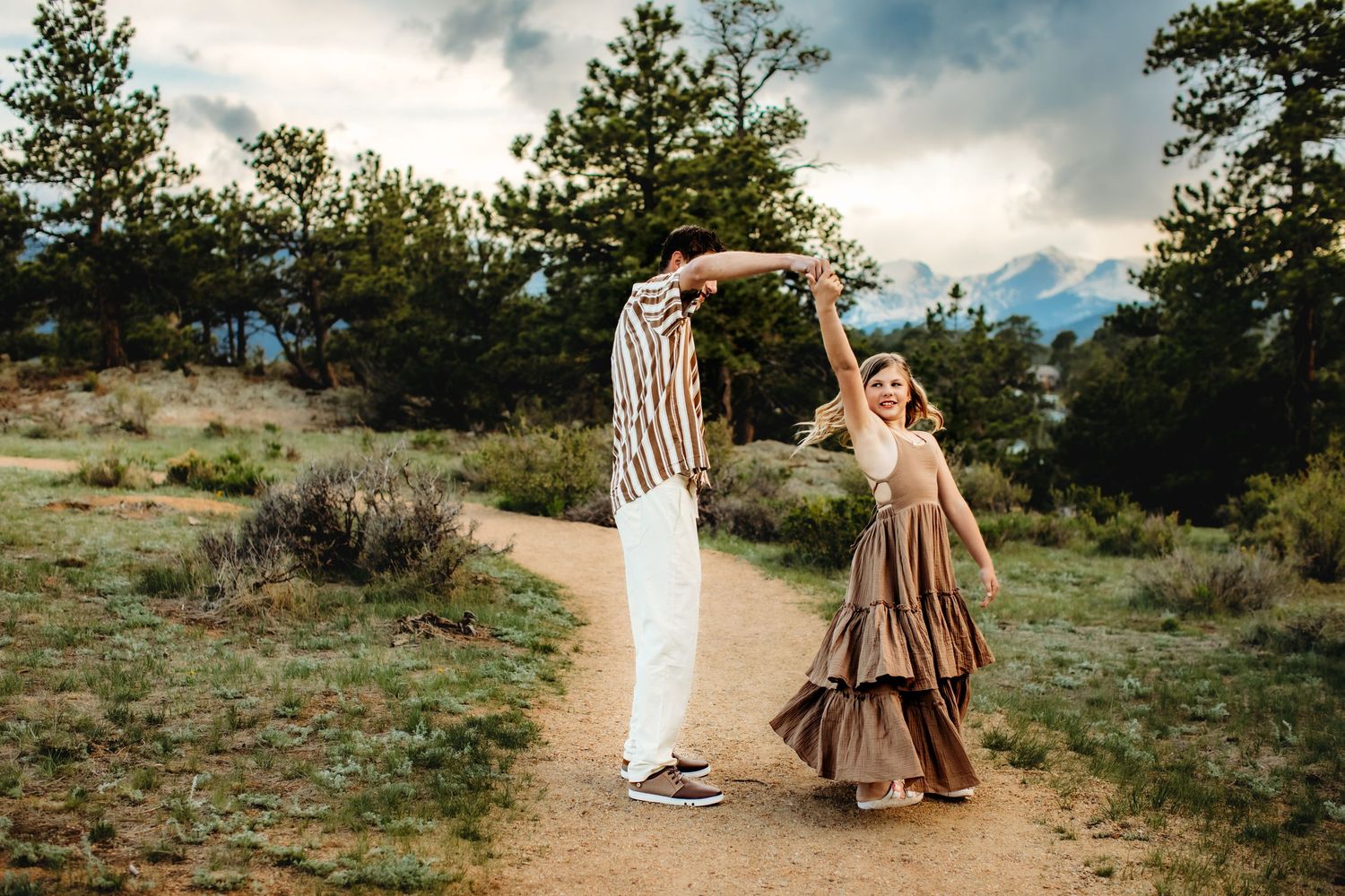 A series of romantic outdoor photos showing couples embracing on a scenic mountain trail during sunset.