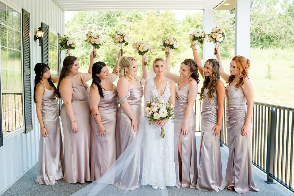 Bride & bridesmaids cheering with their flower bouquets at The Magnolia Estate Rosewood Manor Miamisburg OH Cincinnati wedding photographer