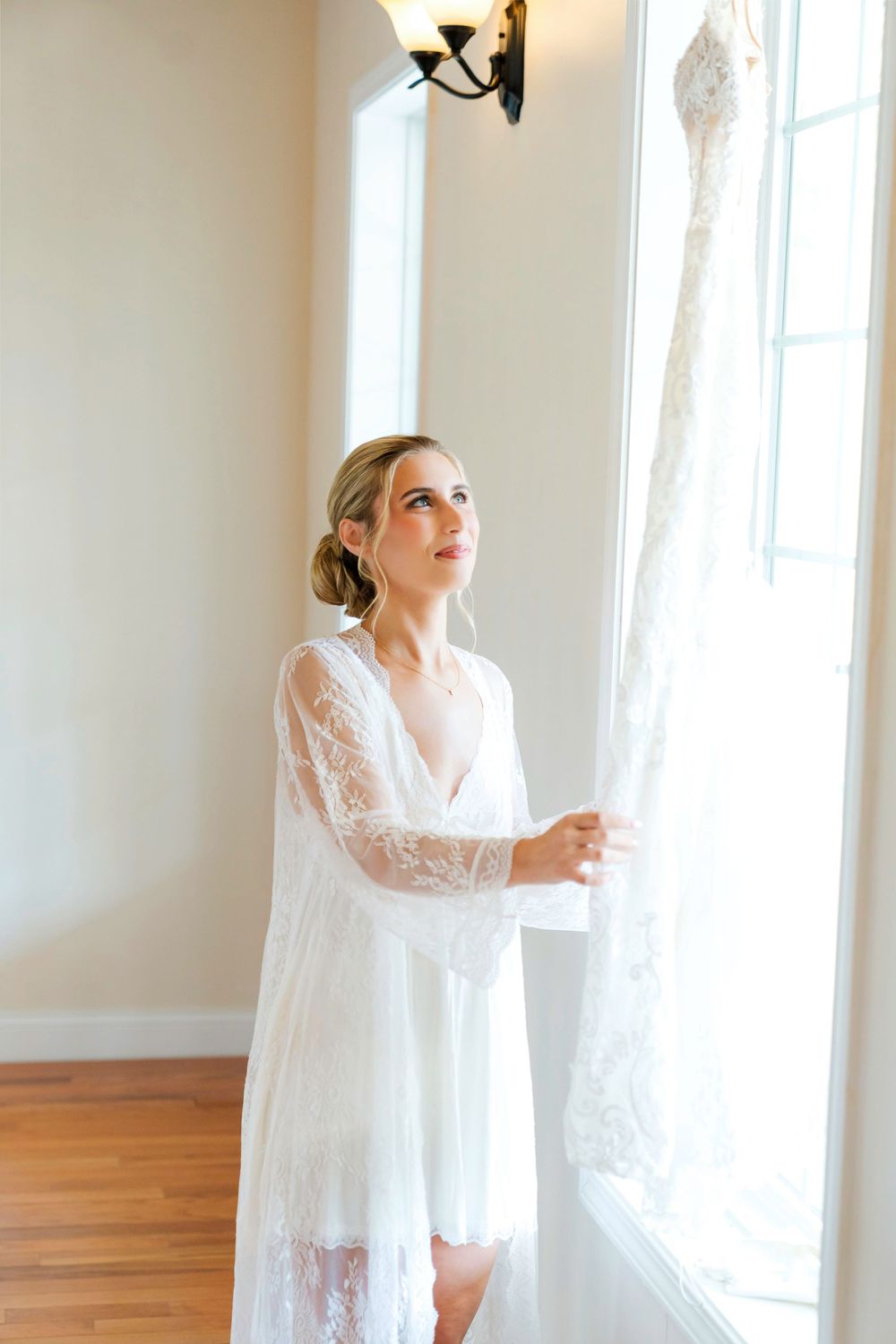 Bride getting ready and looking at her wedding dress at The Magnolia Estate Rosewood Manor Miamisburg Ohio Cincinnati wedding photographer