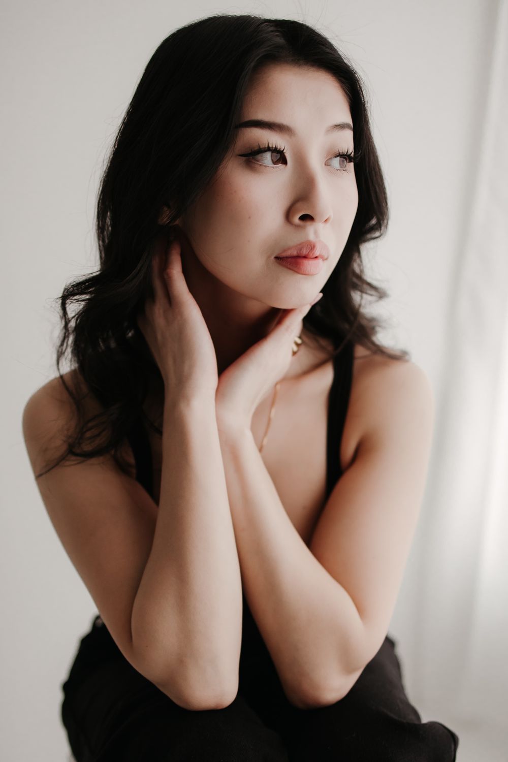 Artistic black and white portrait series showing dramatic poses against a light background.