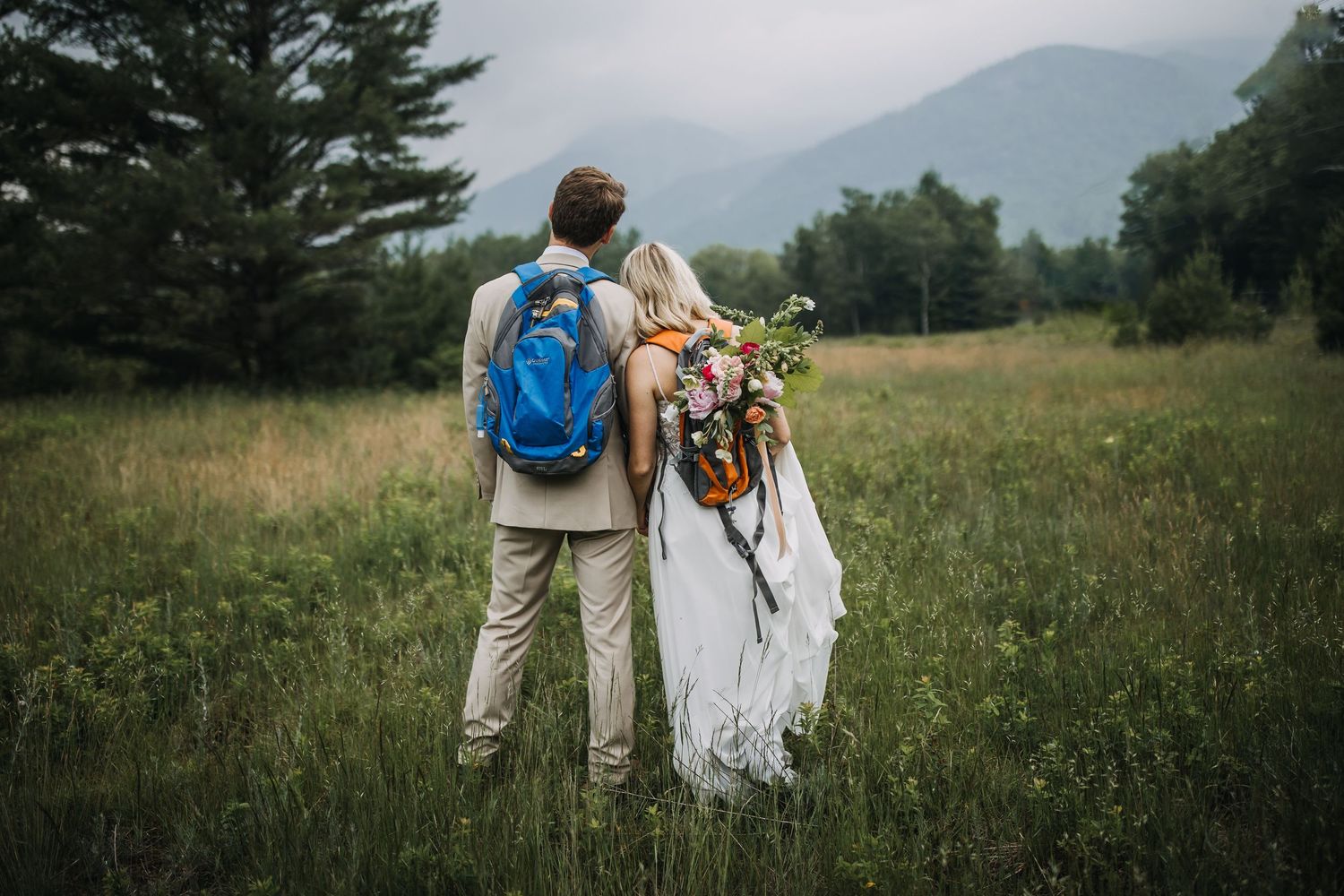 couple eloping with backpacks