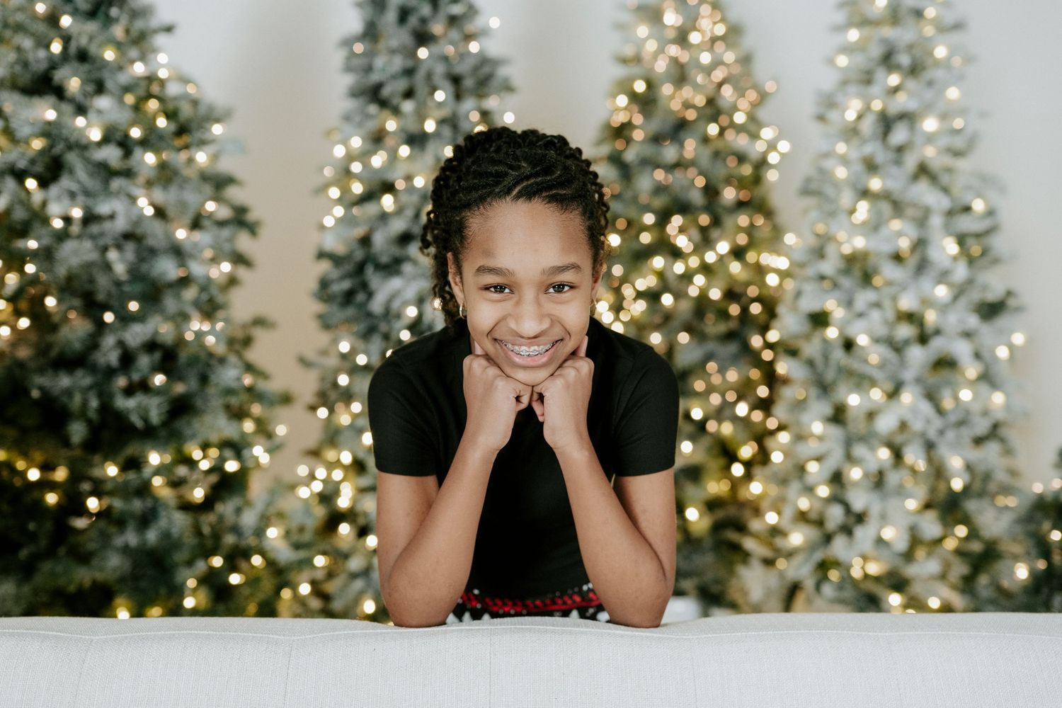 A sequence of festive holiday photos showing decorated Christmas trees with twinkling lights in the background.