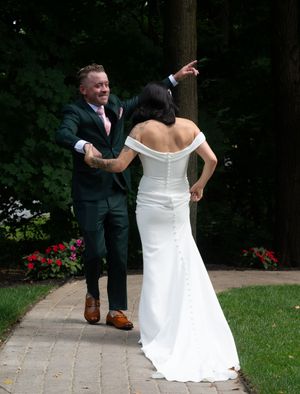 A series of wedding photos showing a couple in formal attire dancing and twirling on a garden path.