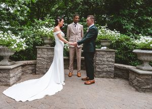Stone pathway surrounded by greenery leads to a romantic outdoor wedding ceremony setting.