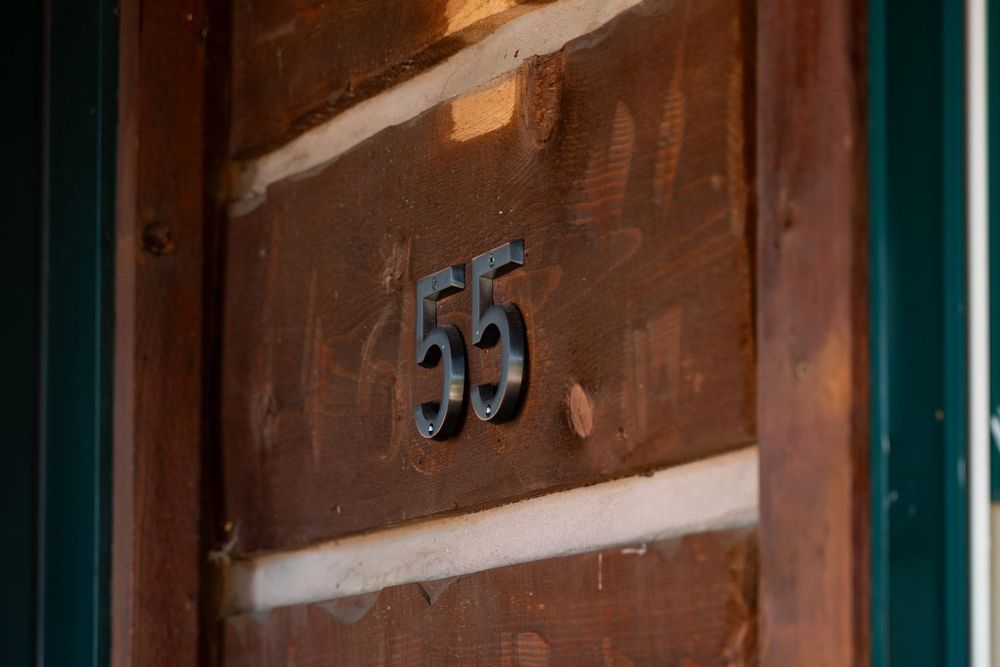 Rustic wooden wall detail with white trim and dark stained finish.