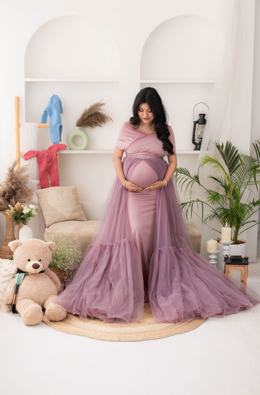 Pregnant woman in lavender gown posing in studio during maternity photoshoot in Hyderabad