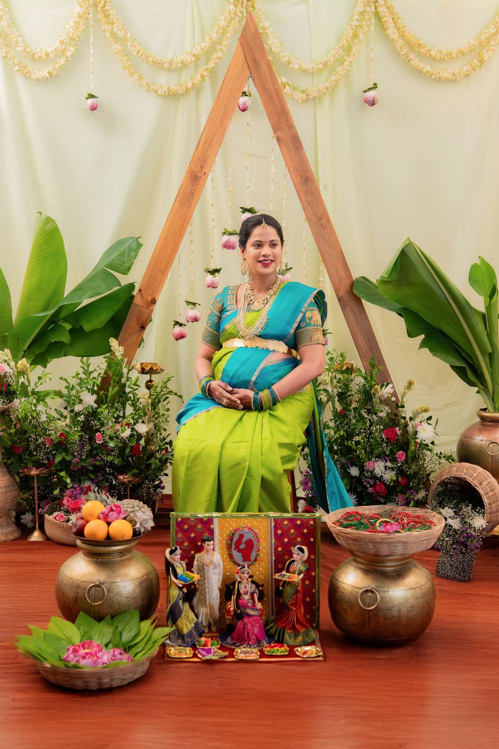 Pregnant woman dressed in traditional attire during cultural maternity seemantham photoshoot setup in Hyderabad