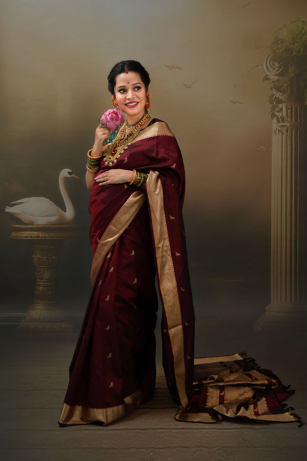 Pregnant woman in traditional saree posing during studio maternity photoshoot in Hyderabad