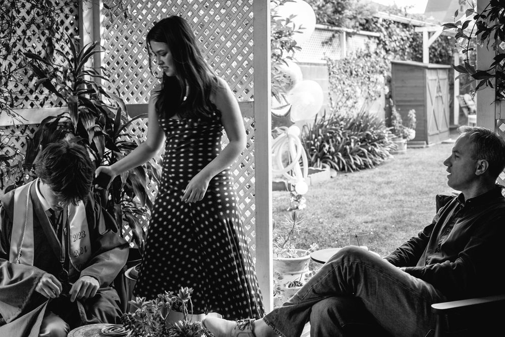 A collection of black and white photos showing various intimate outdoor moments at a gathering.