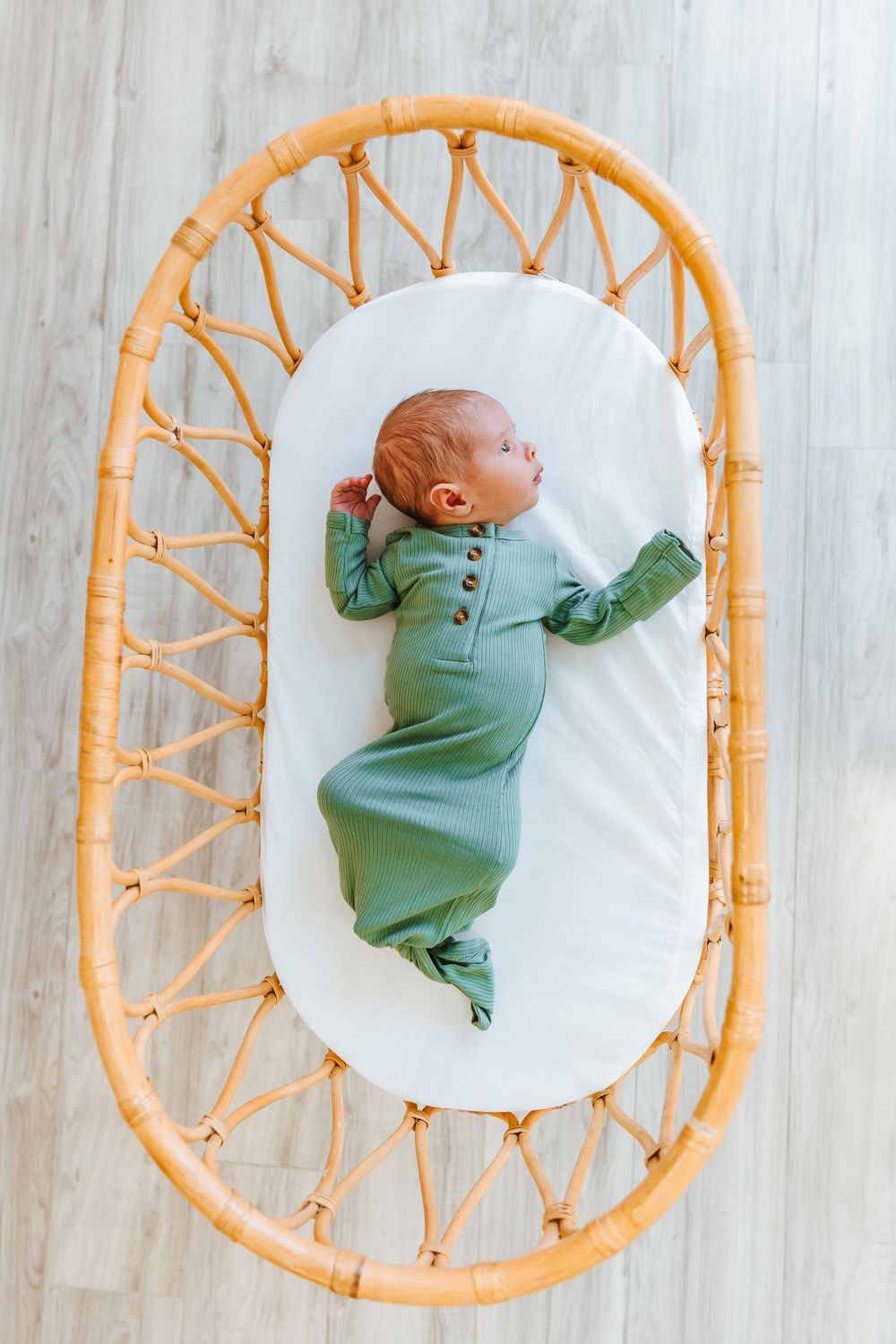 Collection of progress photos showing baby in green onesie on circular bamboo lounger.