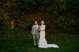 Elegant outdoor wedding portraits with natural greenery backdrop.