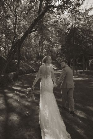 Black and white wedding photos showing couple in romantic garden setting.