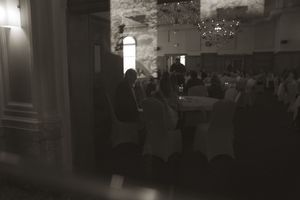 Dark interior shots of a wedding reception venue with dramatic lighting and architectural details.