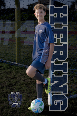 High school soccer player poses with uniform and ball for team photo against large block lettering background.