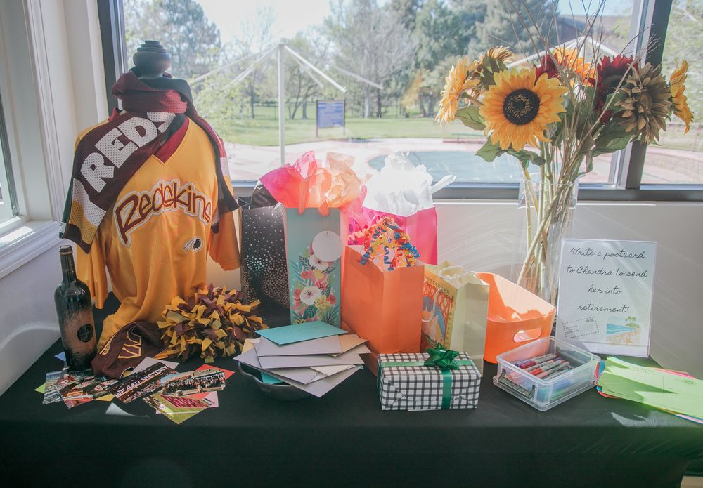 Baseball merchandise and sunflowers displayed on a table with gift bags and decorative items.