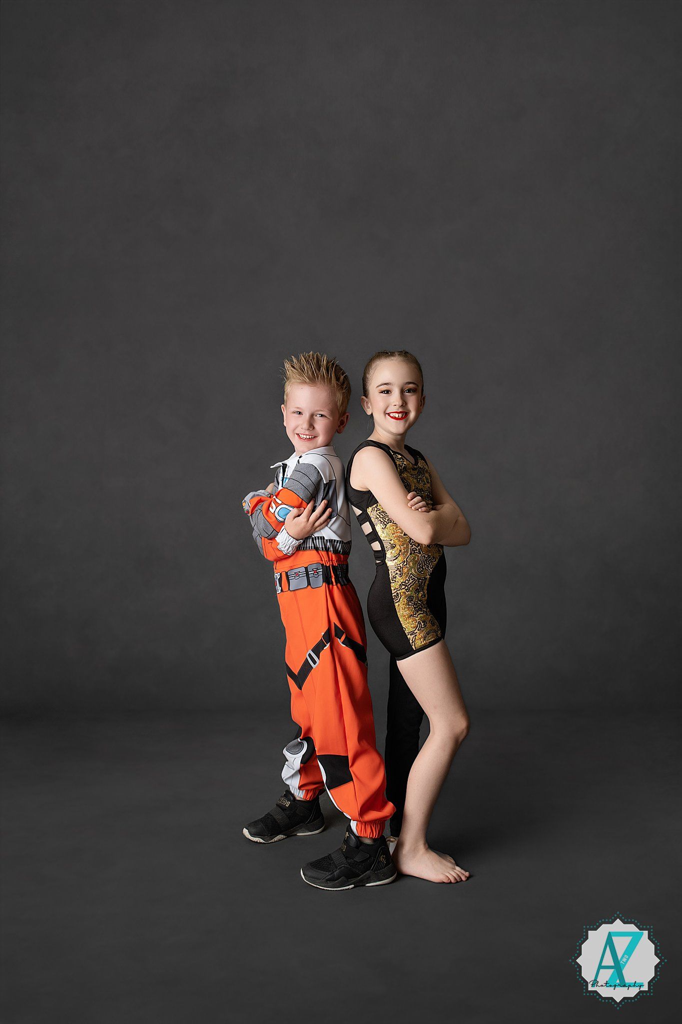Studio photoshoot sequence showing a parent and child in orange safety gear against a dark background.