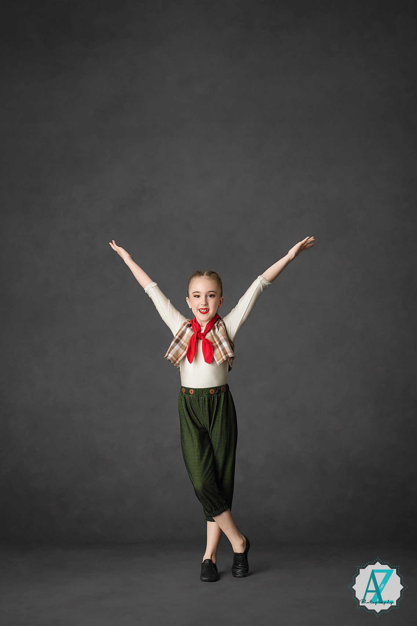 Sequence of images showing young dancer in green dress and red bow performing joyful leaps and jumps on dark background.