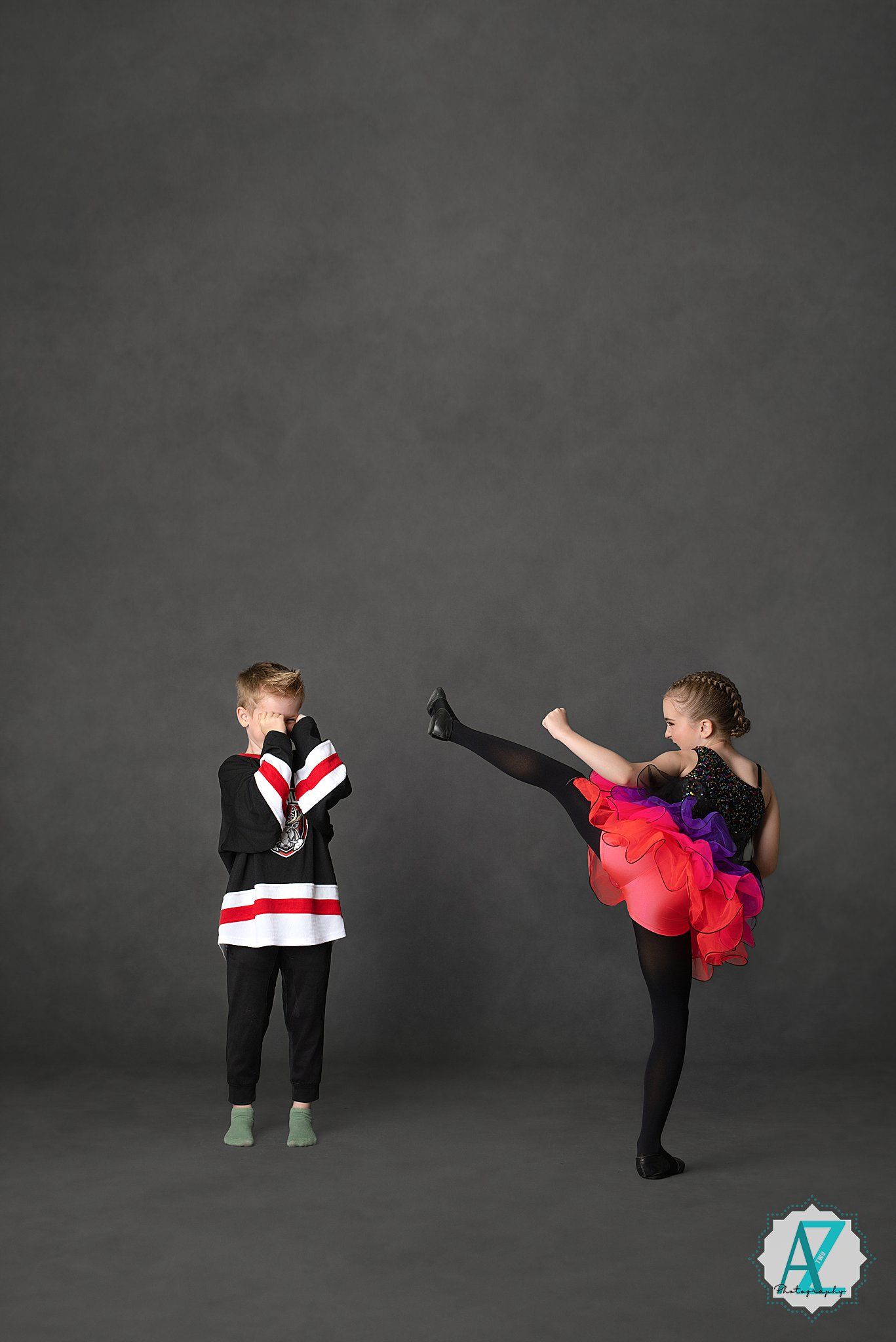 Athletic performer in black and red attire demonstrates a series of dynamic high kicks against a dark background.
