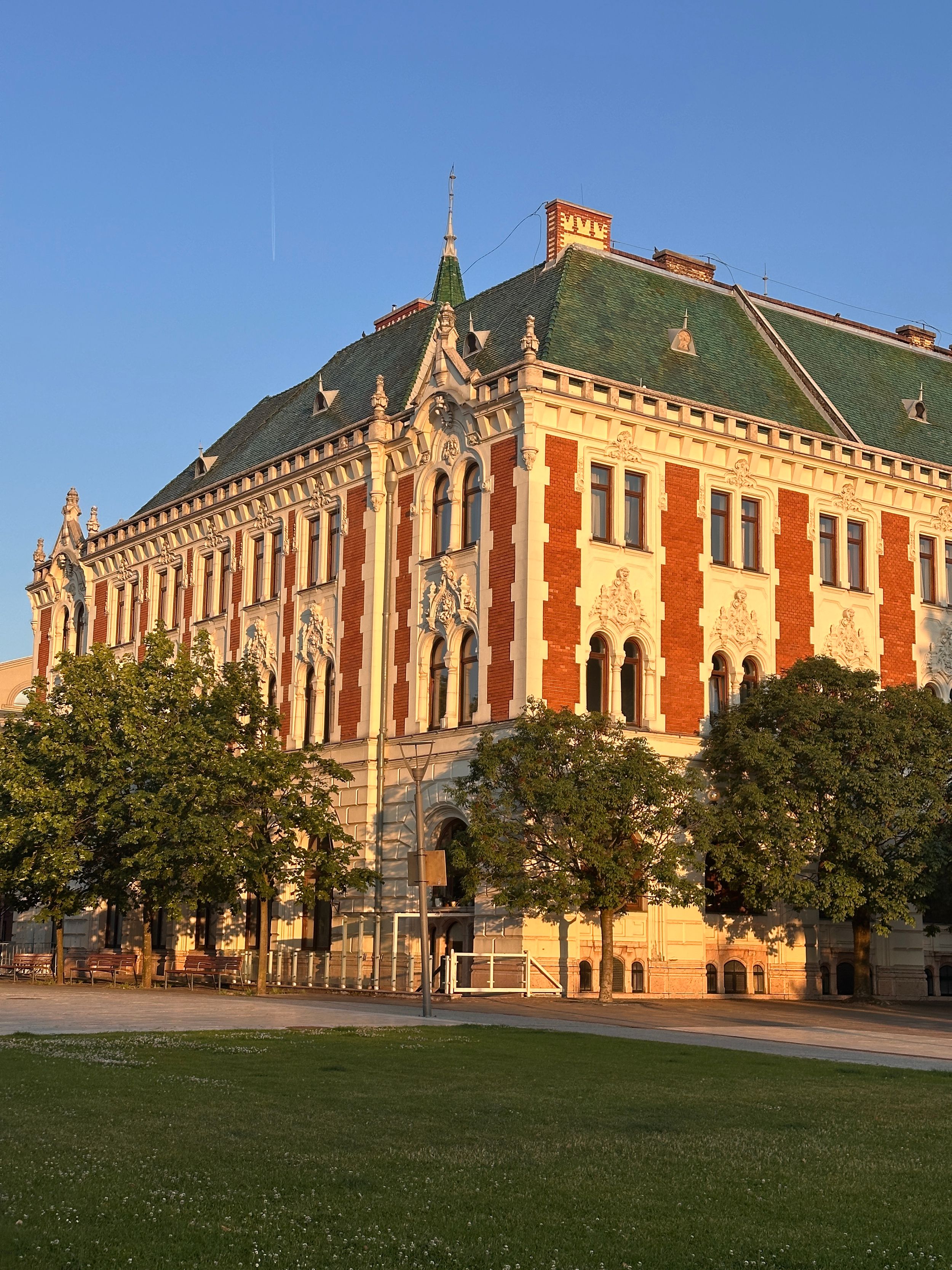 Historic Gothic Revival architecture of the Smithsonian Institution Building gleams with red sandstone against a bright blue sky.
