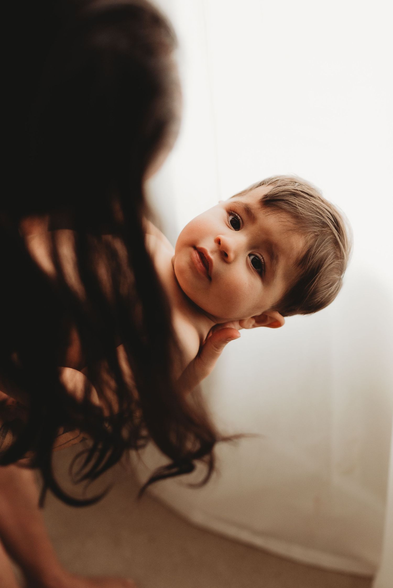Artistic side profile portrait of a baby in natural window light.